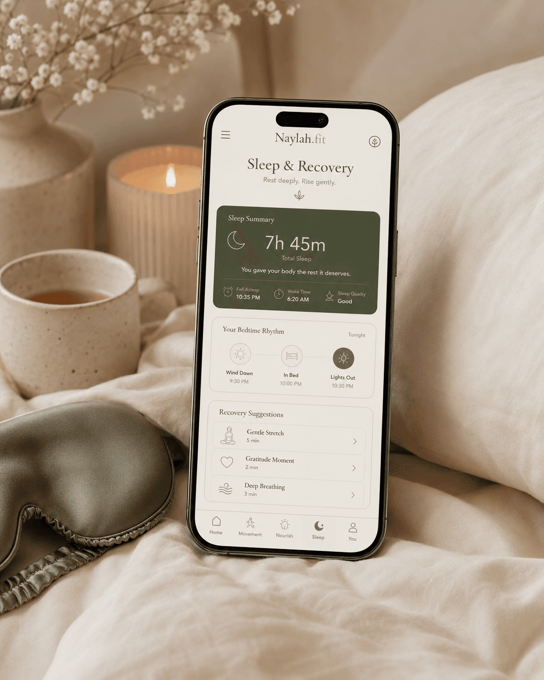 Sleep and Recovery screen resting on bedding by candlelight